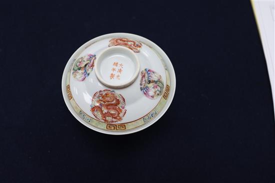 A Chinese celadon glazed dish, a Jun type tripod dish and a famille rose bowl and cover